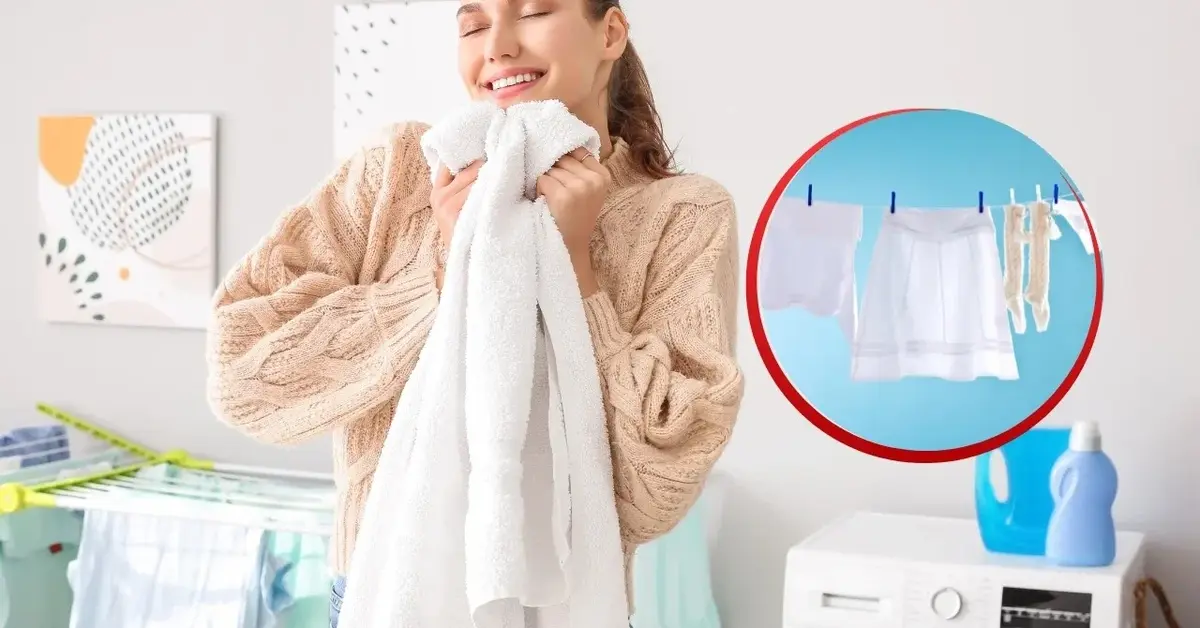 Kobieta cieszy się trzymając białe pranie w rękach. Widać suszące się białe pranie.