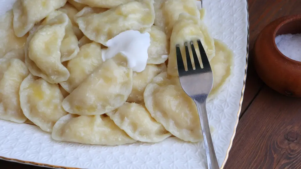 pierogi z serem widelec talerz śmietana