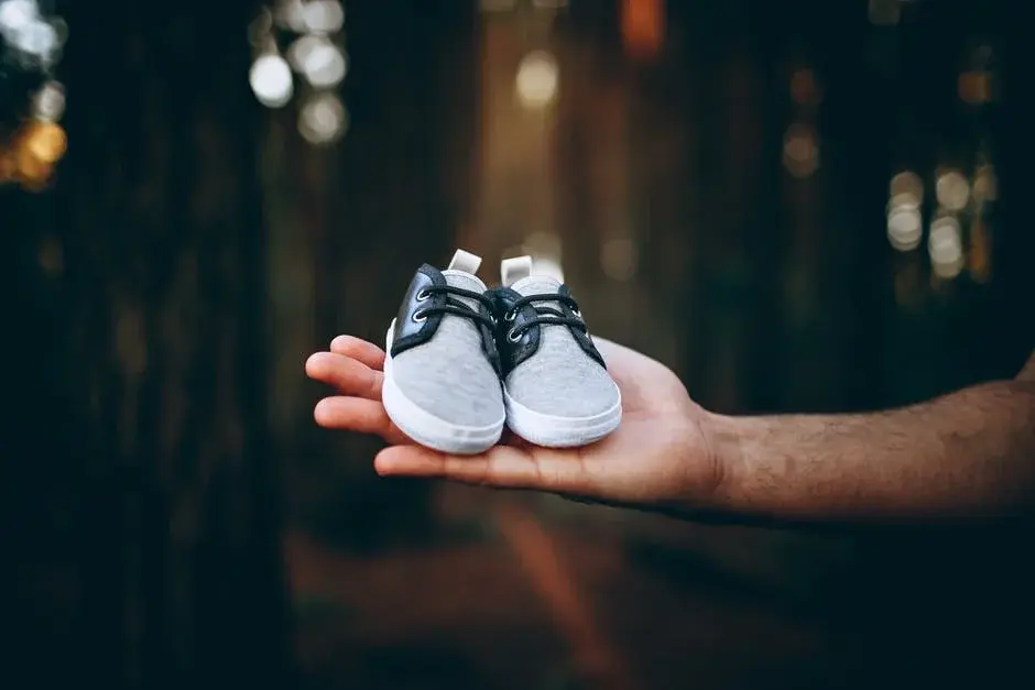 Malutkie buciki dla niemowlęcia leżą na dłoni