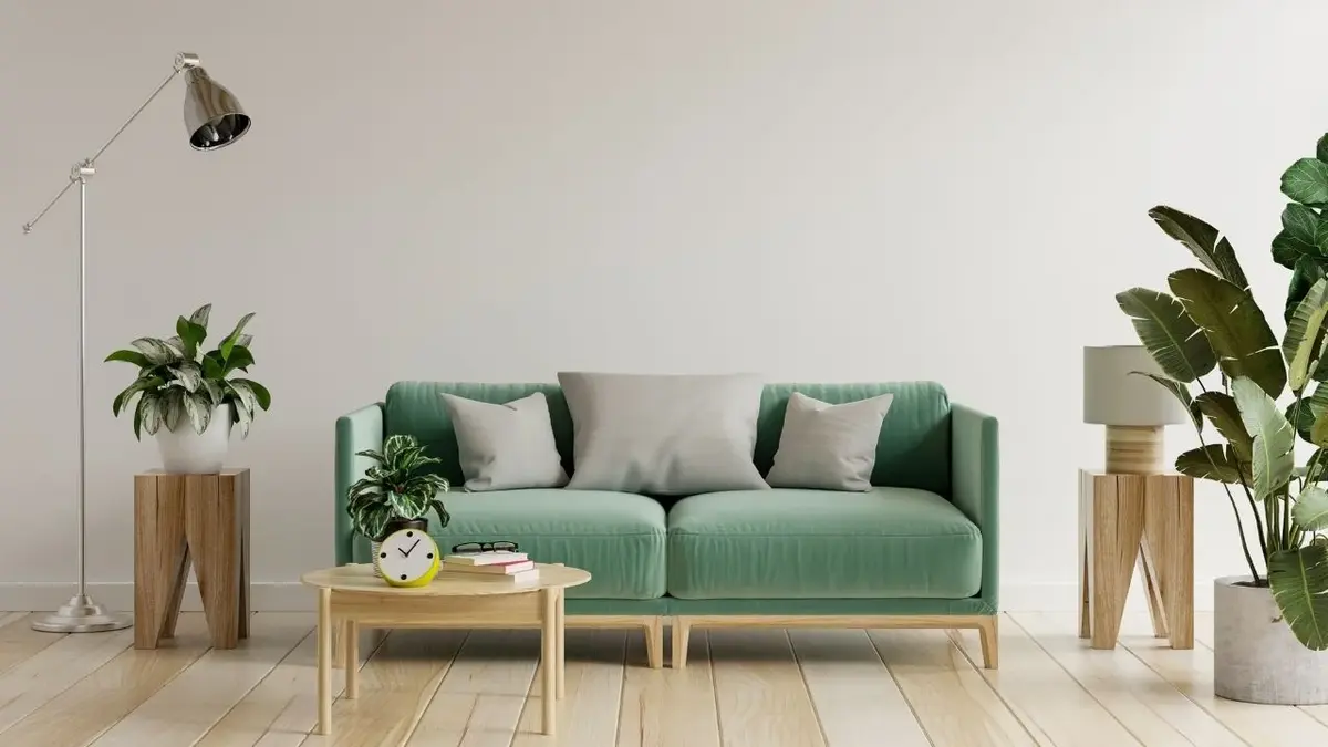 Salon z zieloną kanapą, drewnianym stolikiem i srebrną lampą podłogową