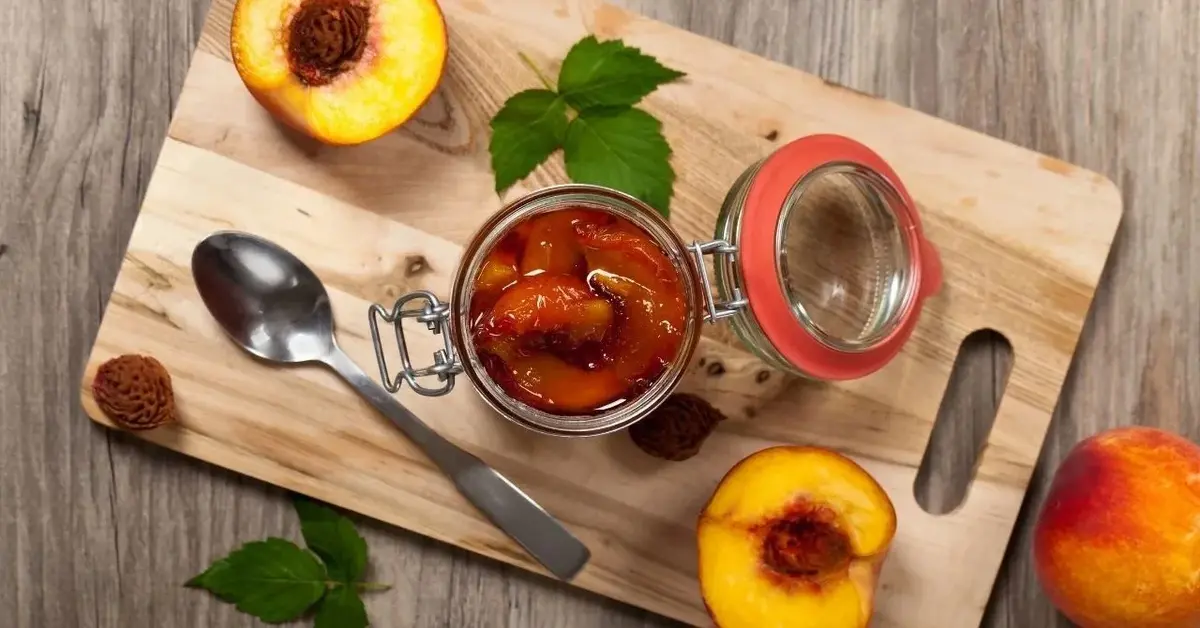 dżem z brzoskwiń z imbirem i rozmarynem w słoiku na desce