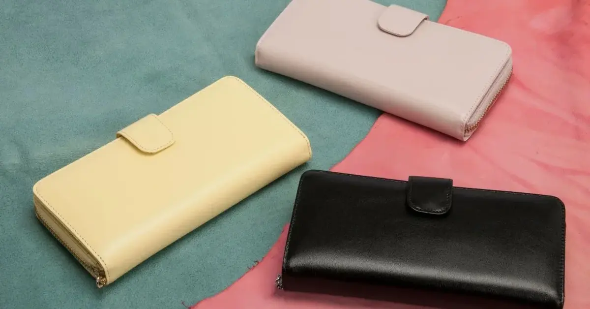 Małe portfele skórzane żółty czarny i kremowy na zielono różowym tle jako najlepsze modele dla kobiet