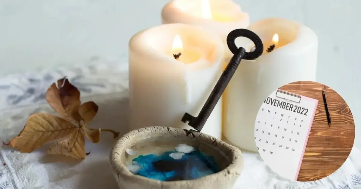 Świece , roztopiony wosk i klucz do wróżenia w andrzejki. Widać zdjęcie kalendarza na stronie listopada.