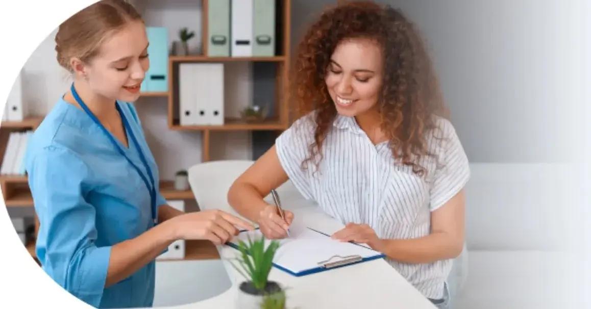 Dwie kobiety pracujące w elektronicznej obsłudze pacjenta w placówce medycznej