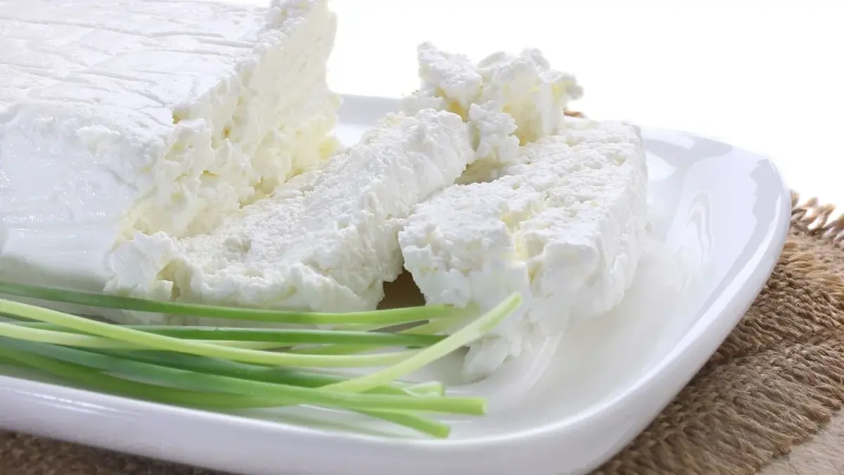 Biały ser i szczypiorek ułożone na białym półmisku