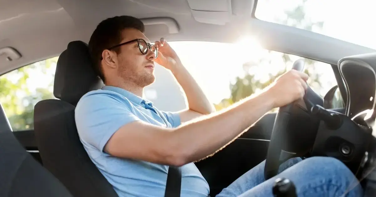 Mężczyzna w okularach jako dbający o wzrok kierowca w samochodzie