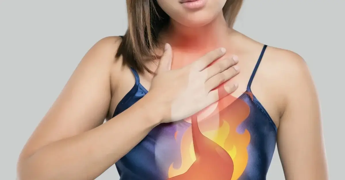 Kobieta trzymająca się za klatkę piersiową z nałożoną grafiką ognia 